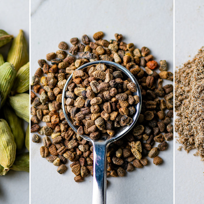 Spoons with cardamom pods, cardamom seeds, and ground cardamom