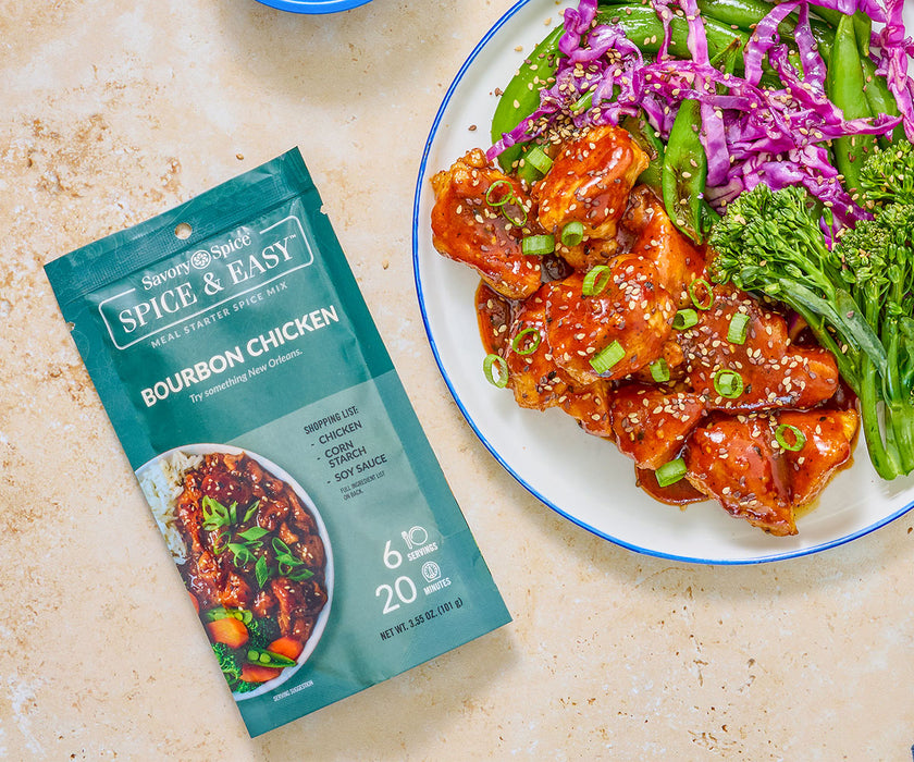 An overhead shot of a package for Bourbon chicken next to a finished plate of made bourbon chicken and sides. 