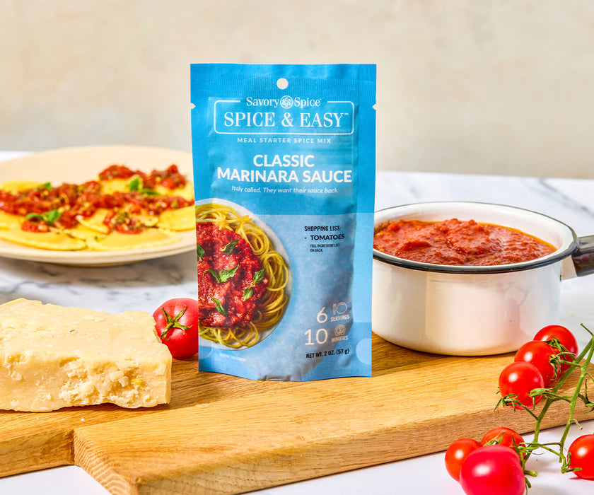 An image of the classic marinara Spice & Easy package next to a bowl of the sauce, fresh tomatoes, and parm cheese. 